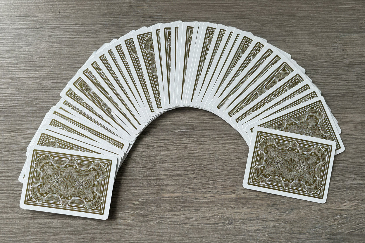 Aristocrat 727 Gold 110th Anniversary deck spread across wood table