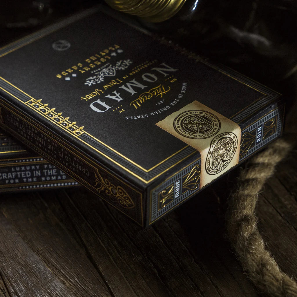 Close-up of a black and gold box with 'Noma3' branding on a wooden surface.
