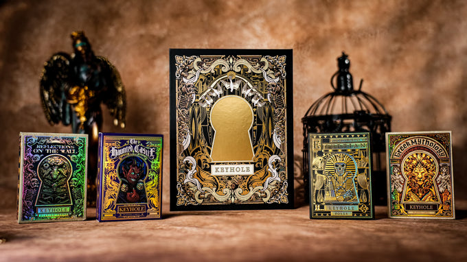 Collection of ornate Keyhole Luxury Edition card boxes with intricate designs on a wooden surface.