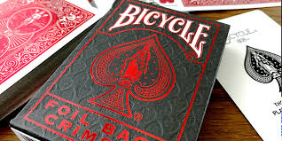 Bicycle Crimson Metalluxe Foil Back playing cards with red and black design.
