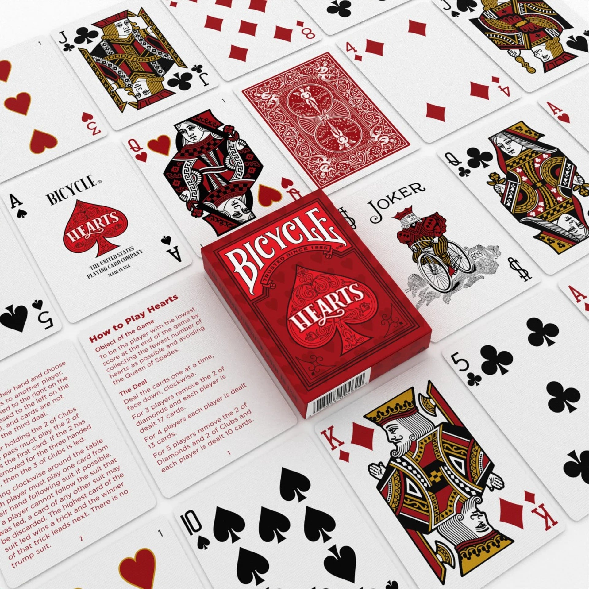 Bicycle Hearts playing cards with cards spread out around them