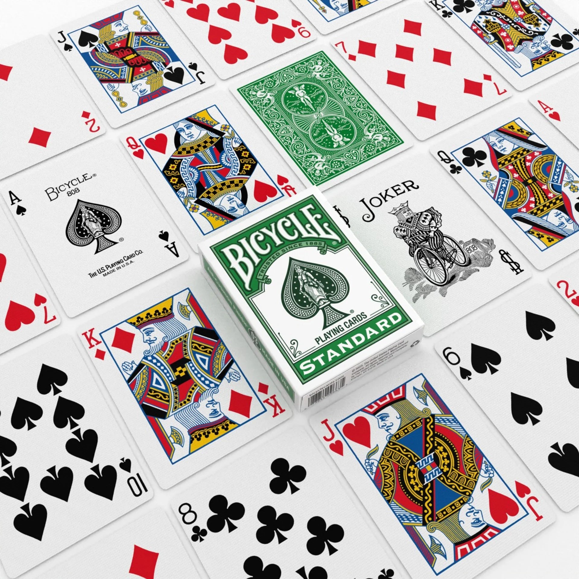 Bicycle playing cards with various card faces displayed around a box.