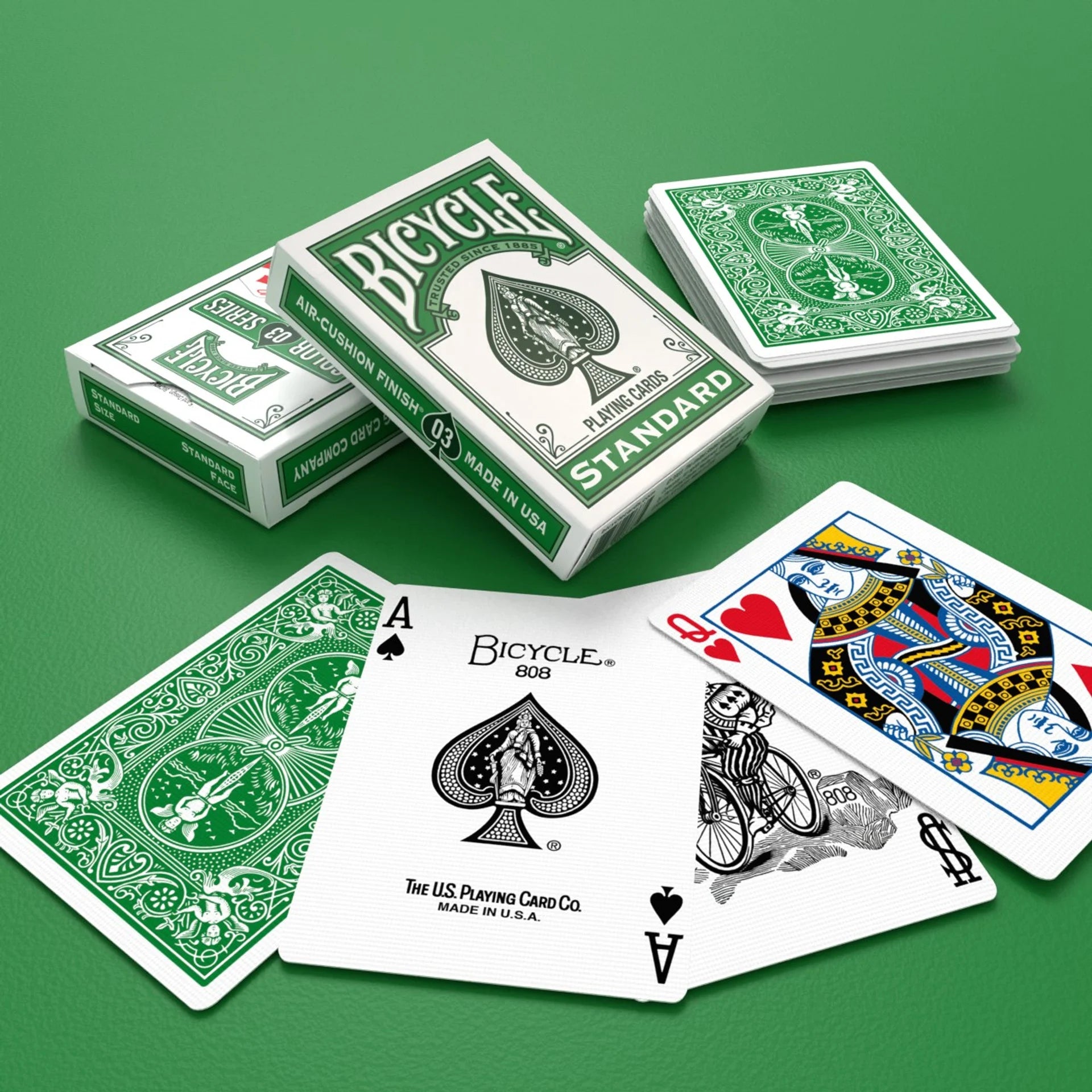 Bicycle playing cards with packaging on a green background