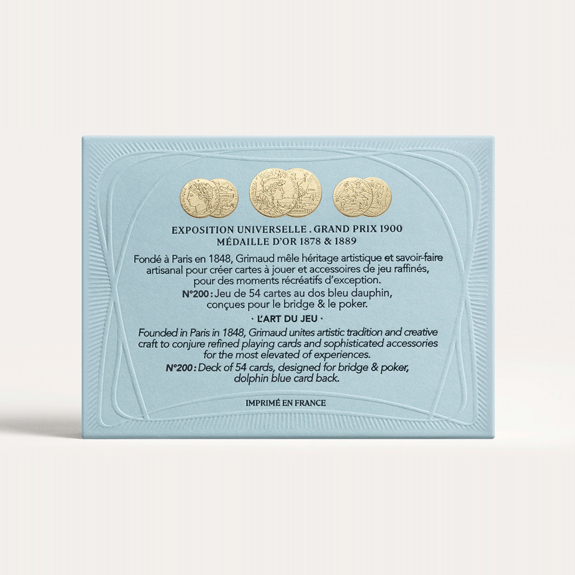 Grimaud dolphin blue card box with gold coins and text on a white background