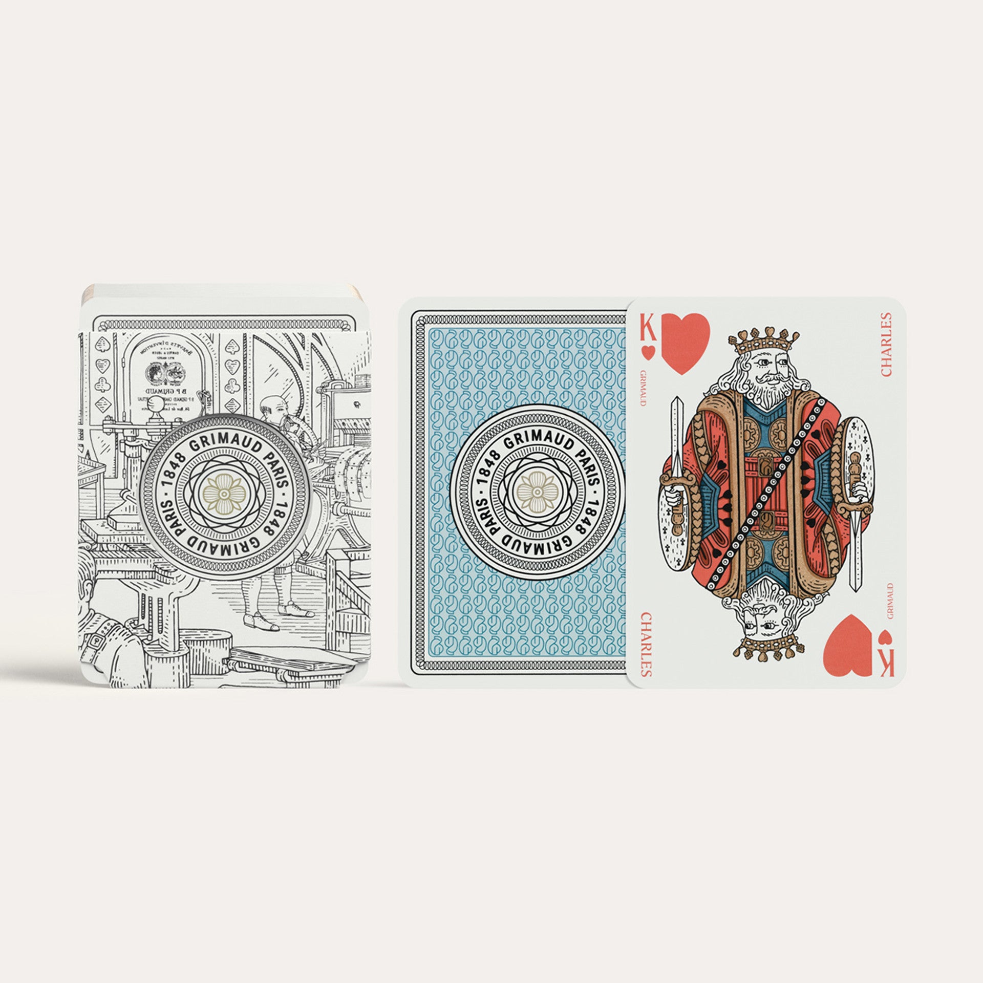 Three playing cards from the Grimaud N°200 Cartes à Jouer Dolphin Blue deck on a white background