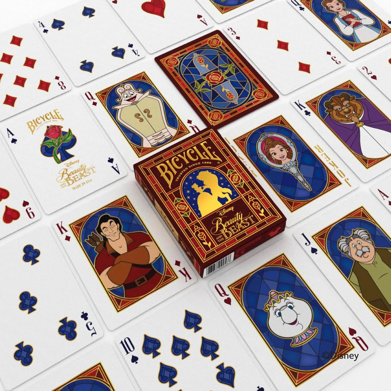 Bicycle Disney Beauty and the Beast deck spread out with Belle, Beast, and supporting character cards around stained‑glass rose backs.