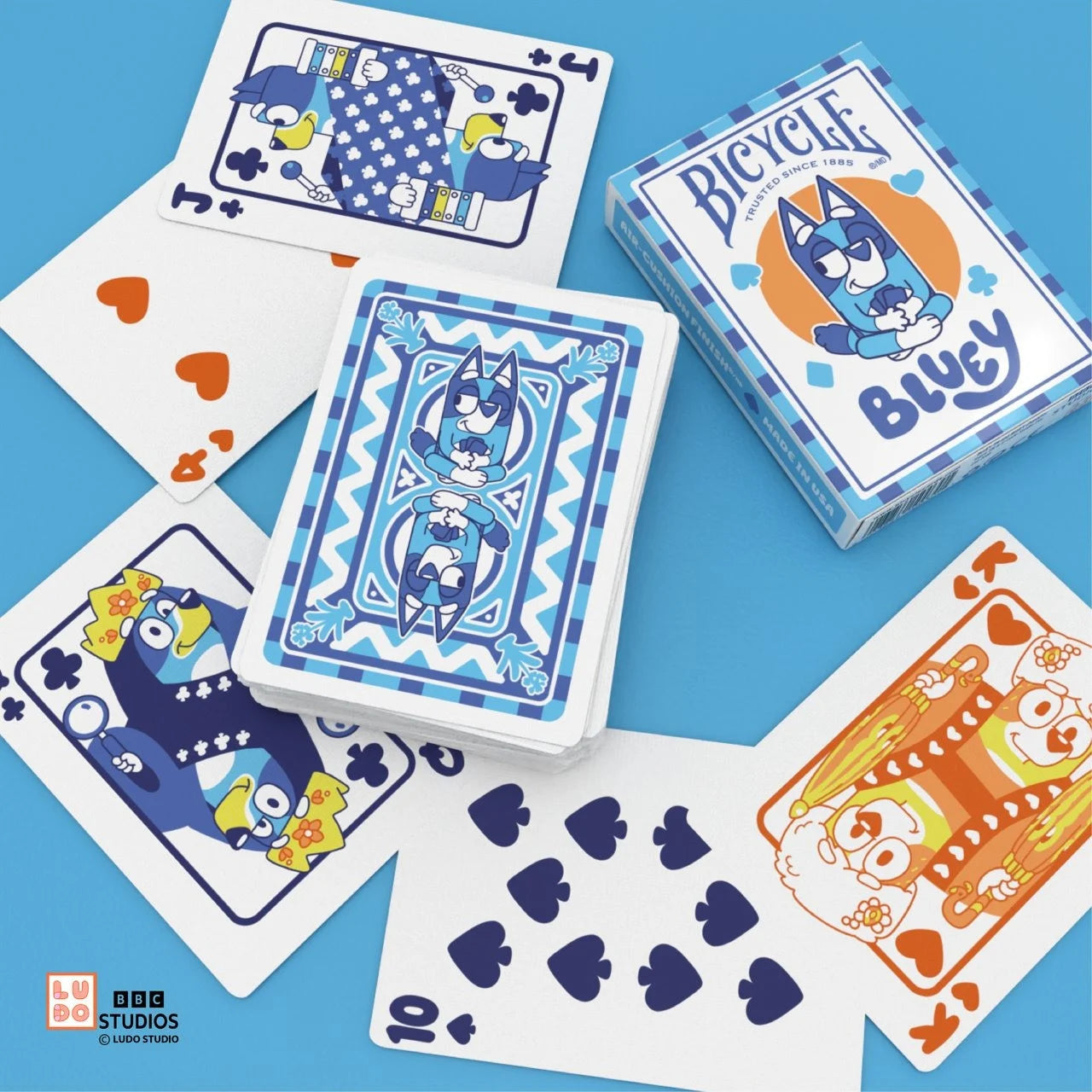 Bicycle Bluey deck on white table showing Heeler family court cards and Bluey card backs.