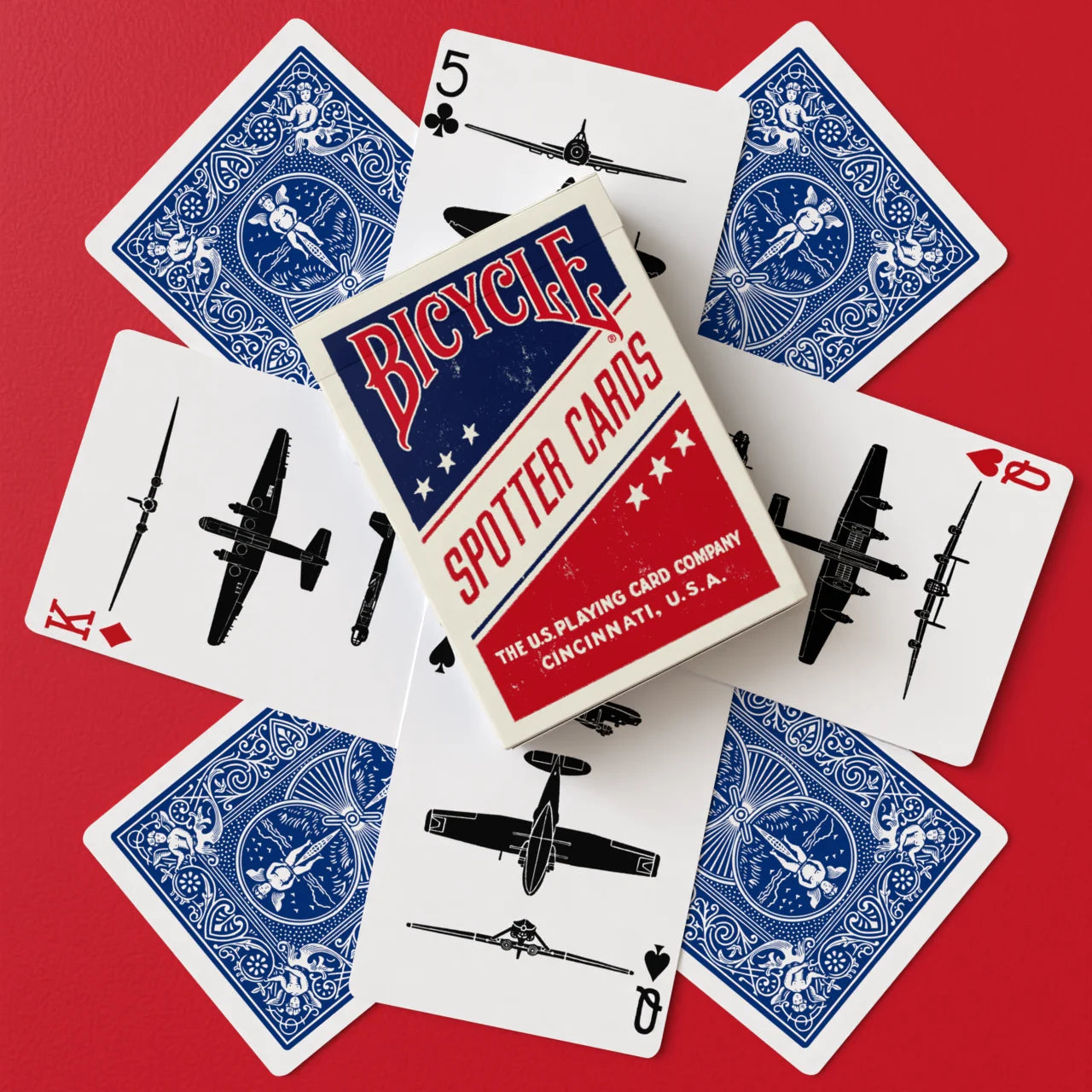 Bicycle Spotter Blue playing cards with blue Rider Back cards, aircraft silhouettes, and vintage tuck box on red background
