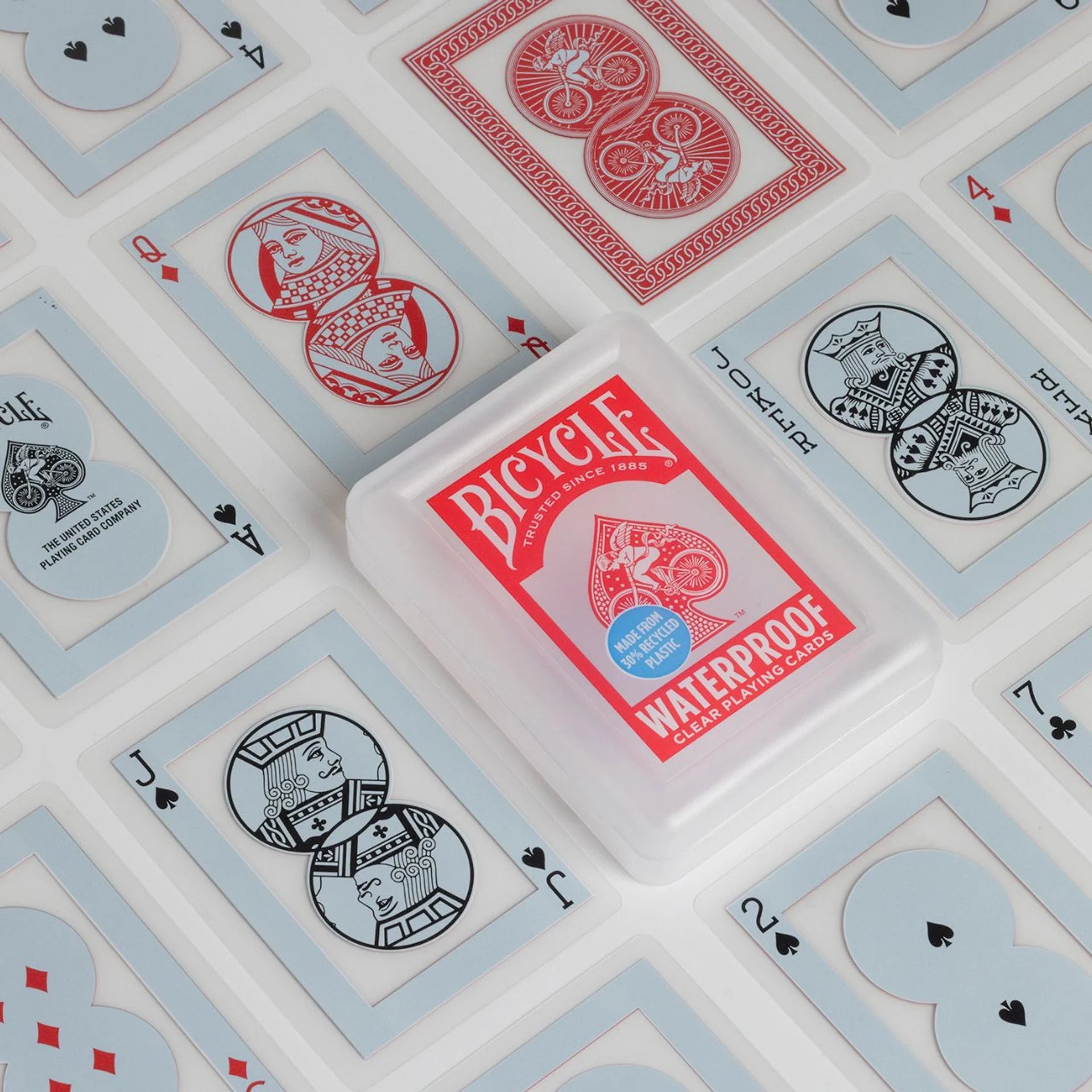 Bicycle playing card deck with waterproof label on a background of playing cards.