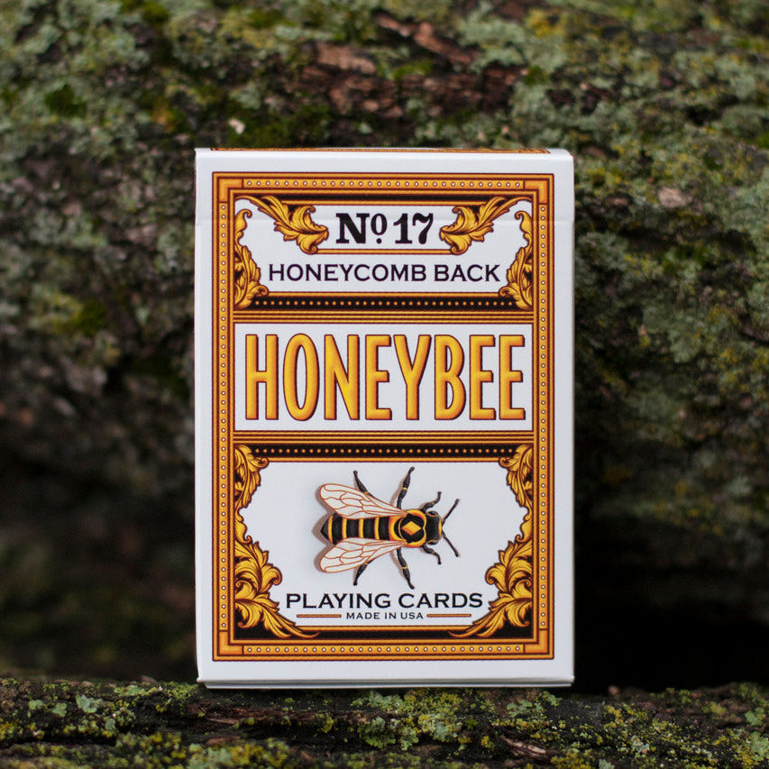 Honeybee playing cards packaging on a textured surface