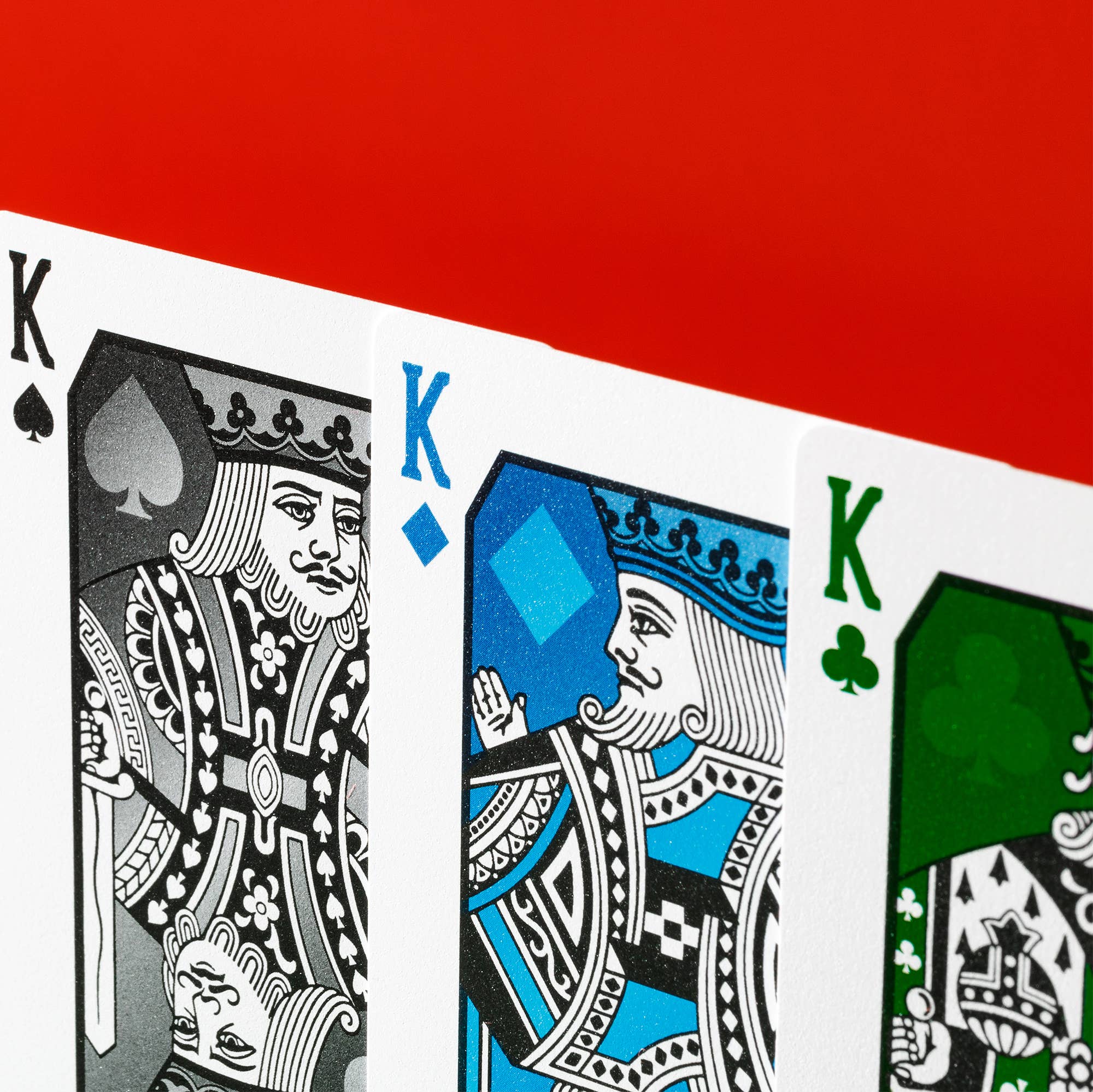 Vanda Aces Red Four kings from different card suits on a red background