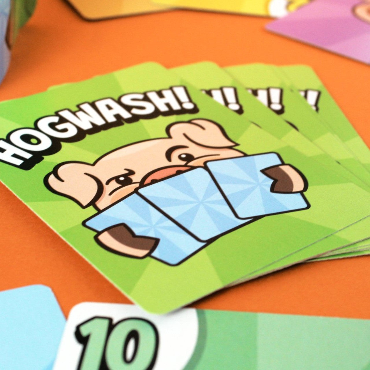 Close-up of green Bicycle Hogwash card backs with pig illustration