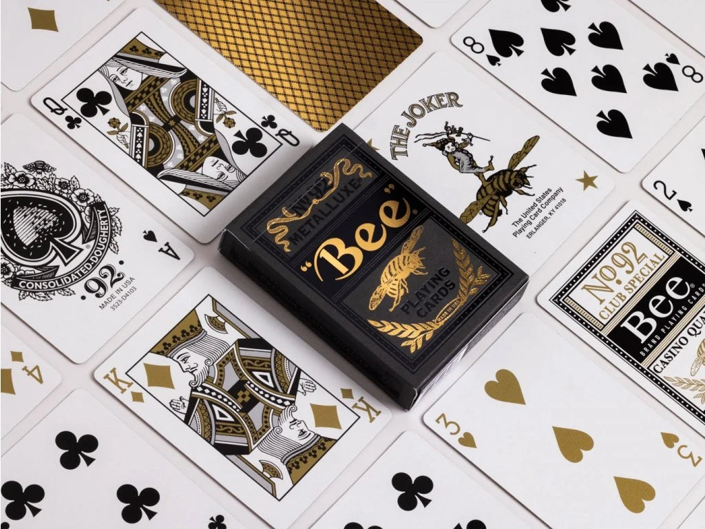 Gold Metalluxe playing cards with 'Bee' branding on a white background