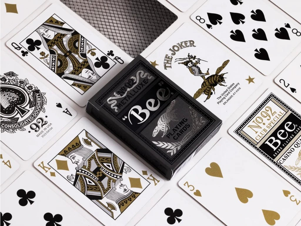 Silver metalluxe playing cards with 'Bee' branding on a white background