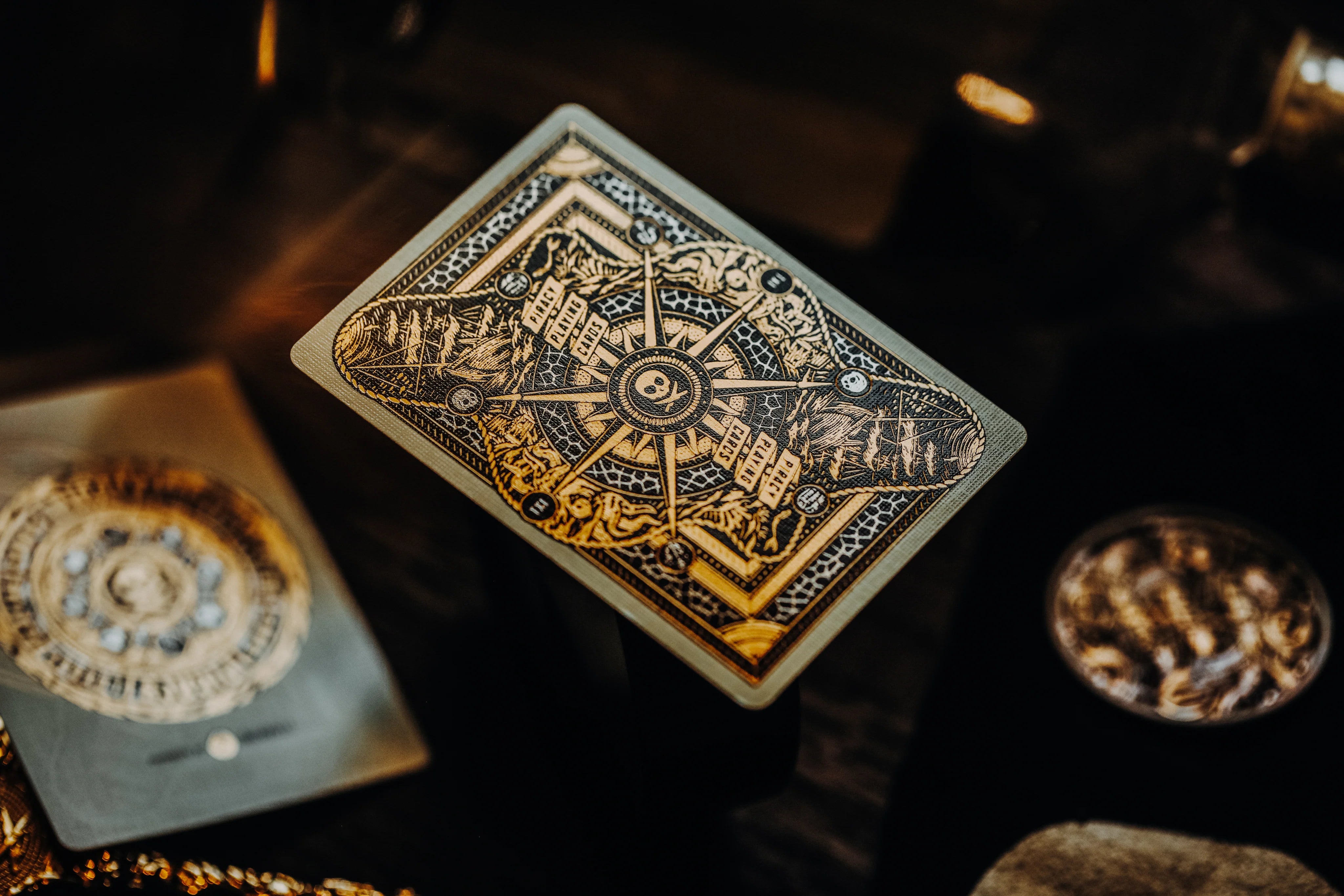 Decorative Piracy playing card with intricate design on a dark background