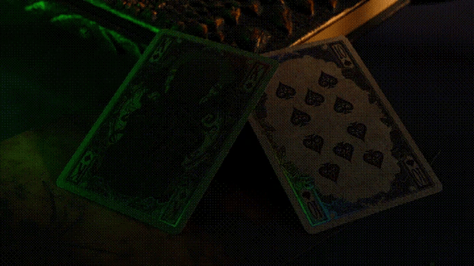 Glowing playing cards with black heart symbols on a dark background