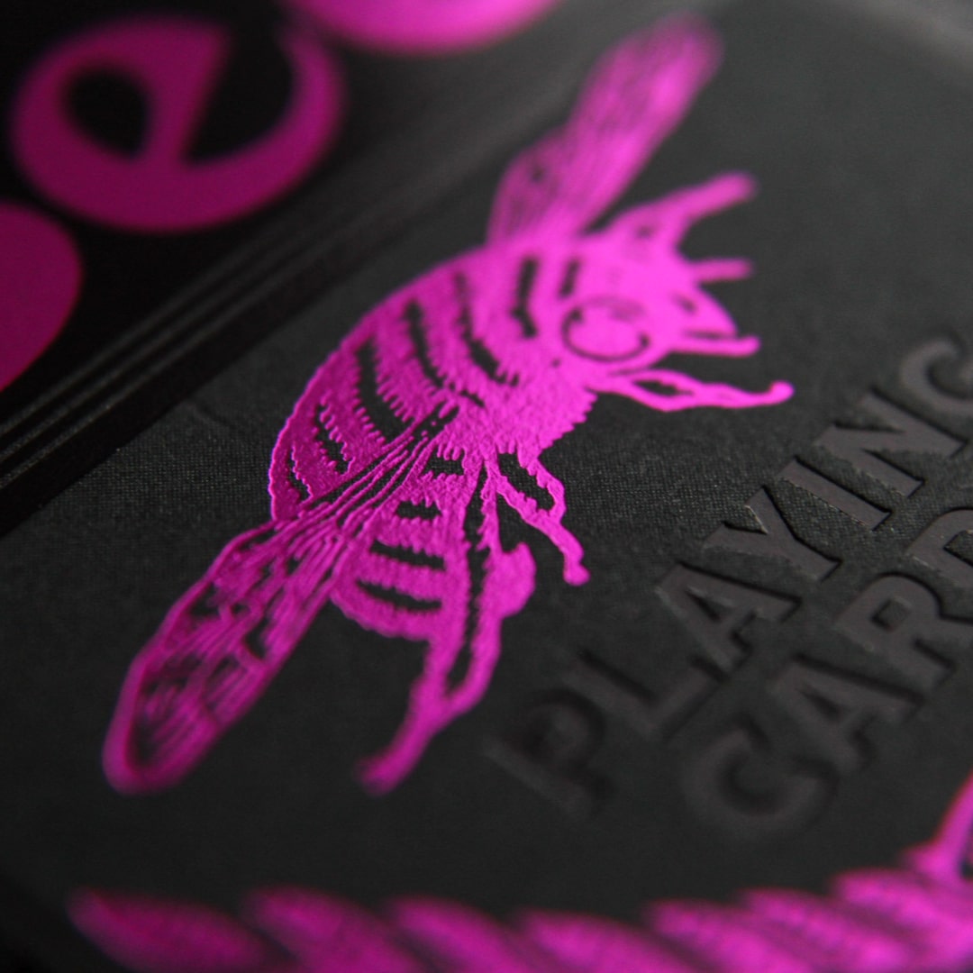 Close-up of a Bee Magenta & Black Metalluxe black surface with magenta bee design.