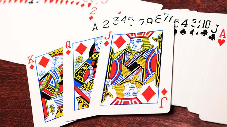Playing cards displayed on a wooden surface