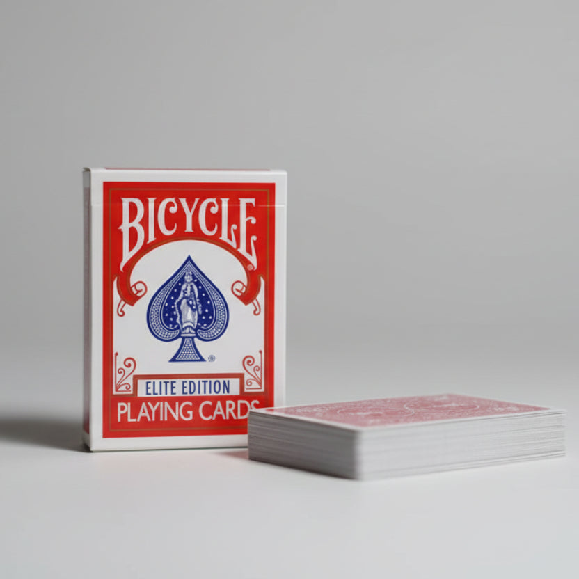 Bicycle Elite Edition playing cards on a wooden surface with a dark background