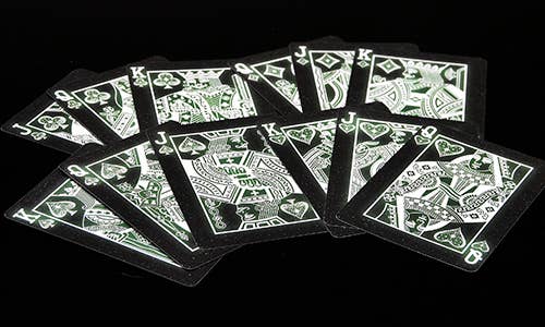 Set of playing cards with a black and white design on a black background