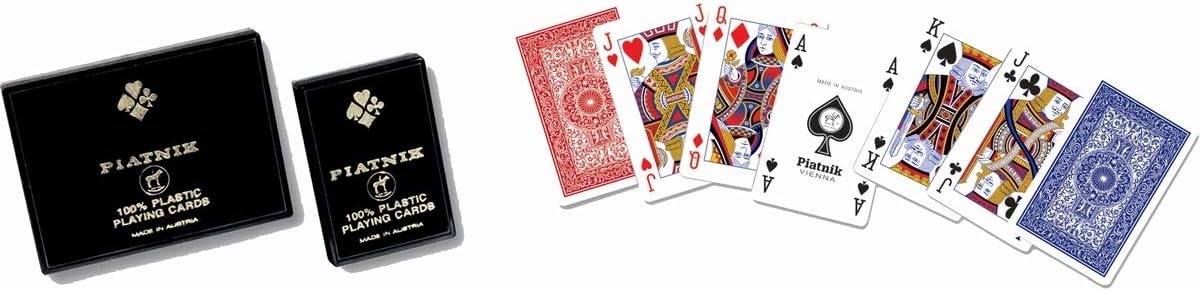Two black playing card decks and a spread of cards including jokers on a white background.