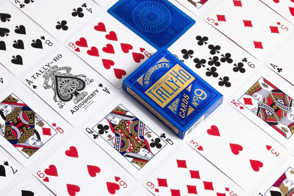 Blue metalluxe deck of Tally Ho playing cards on a white background with card faces.
