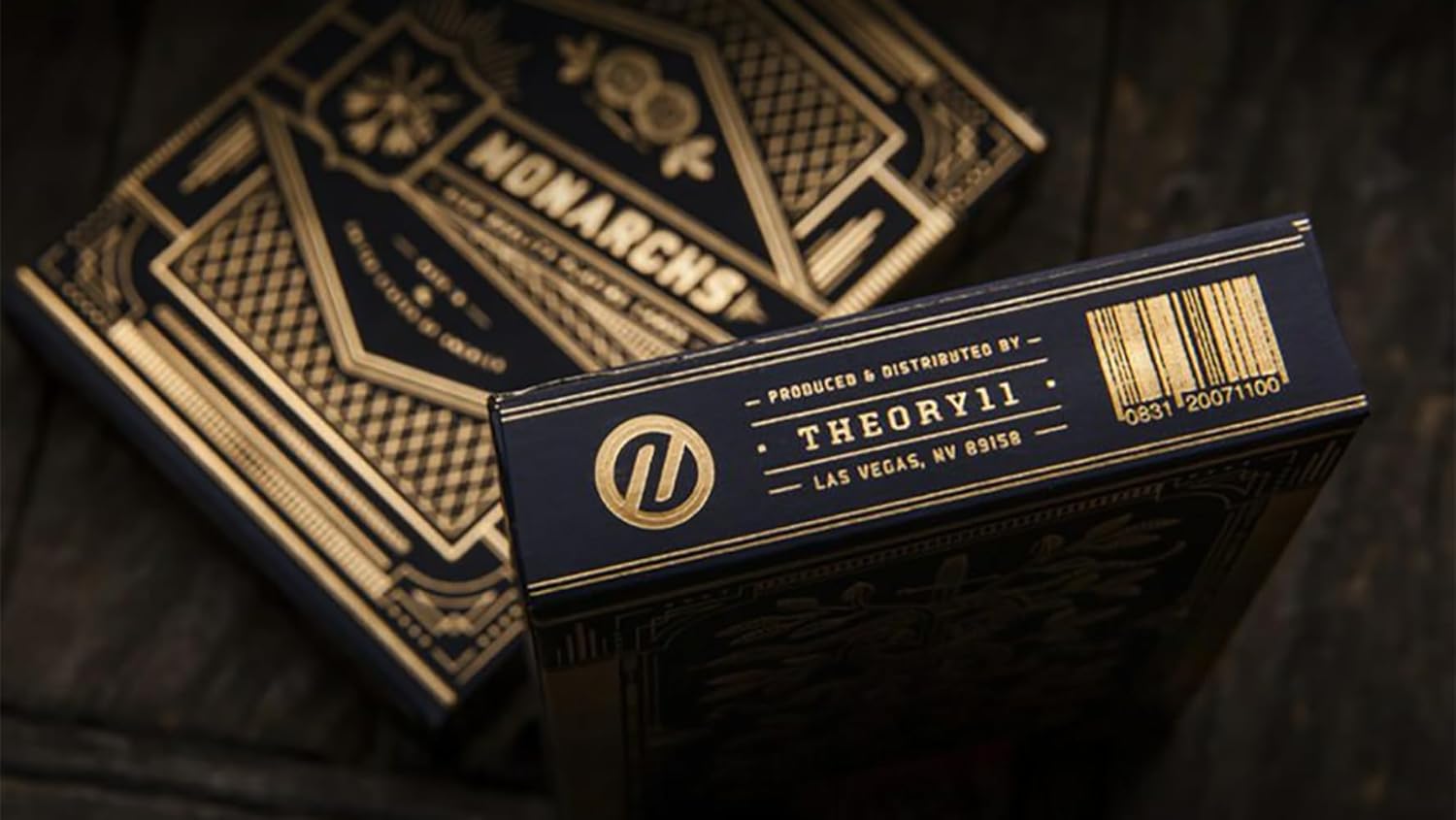 Theory11 Monarch playing cards with gold text on a dark background