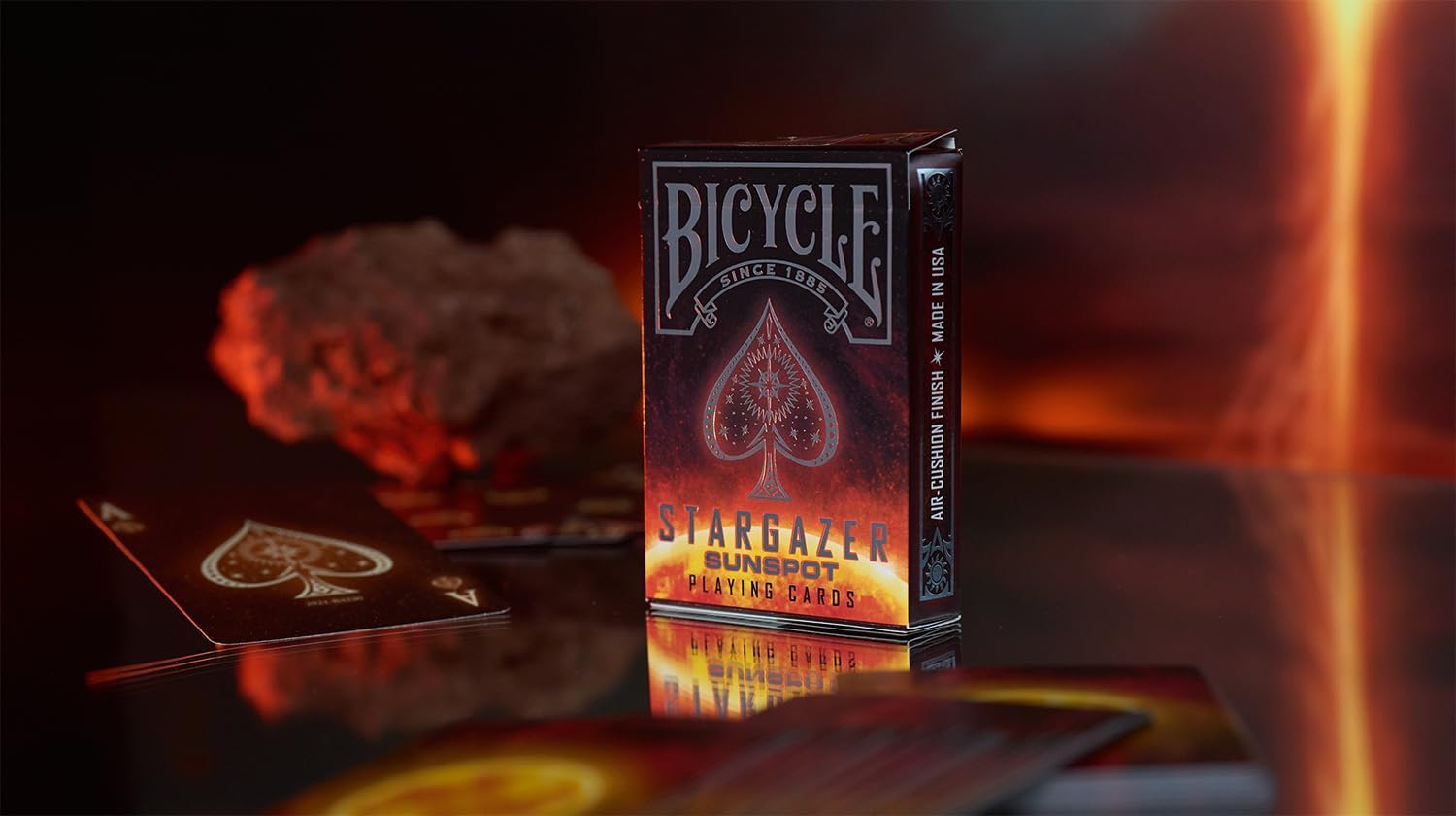 Bicycle Stargazer playing cards box on a reflective surface with cards in the background