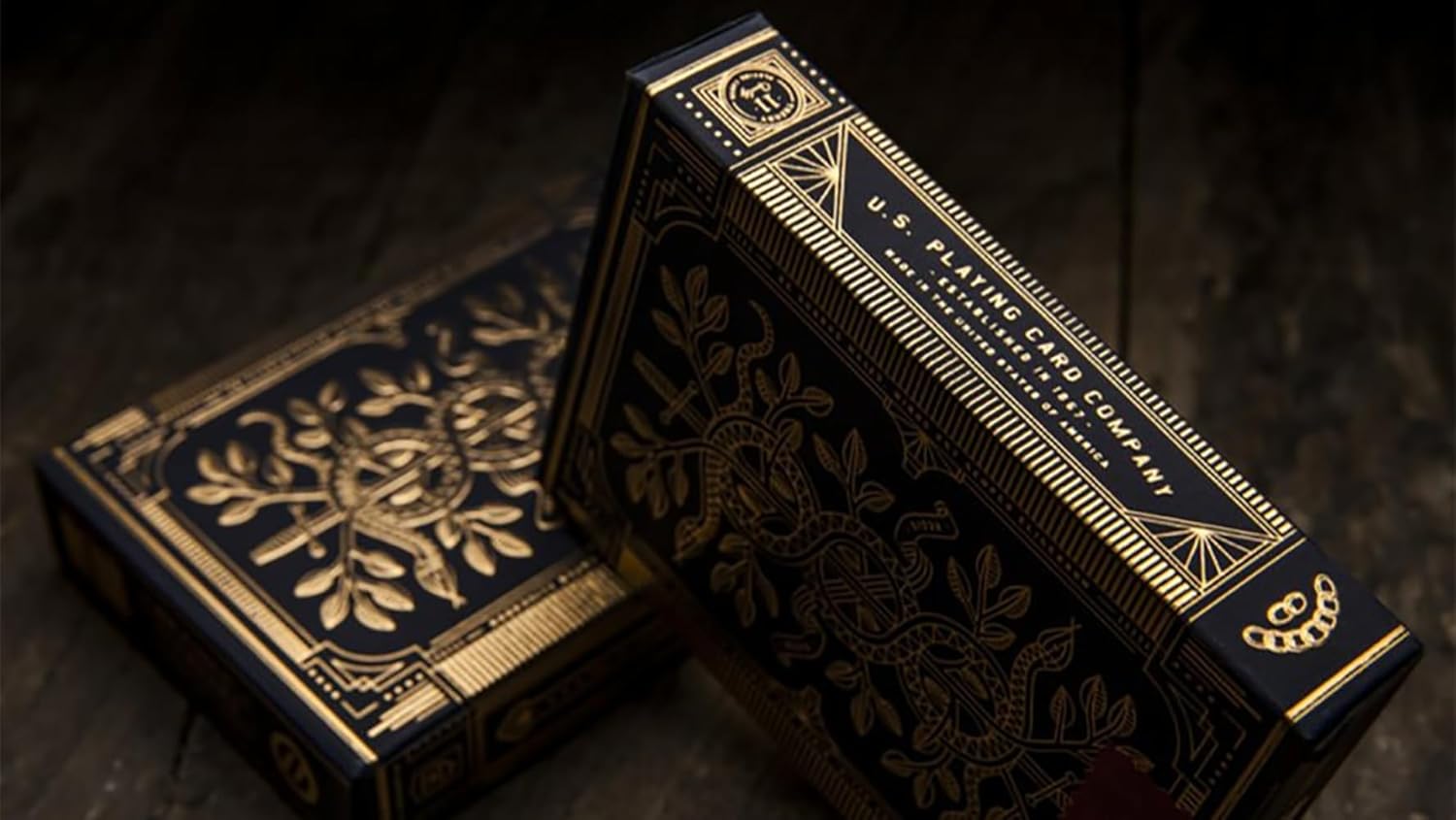 Decorative black and gold box with intricate designs on a dark background