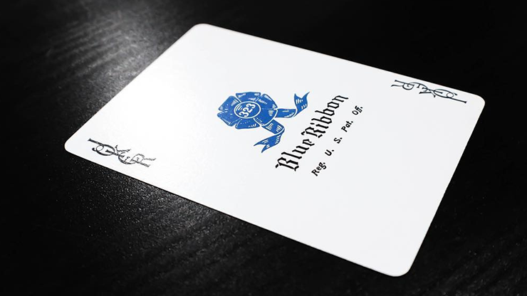 White Blue Ribbon card with blue logo and text on a dark surface