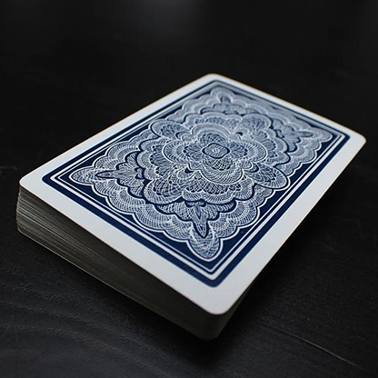 Stack of Blue Ribbon playing cards with a blue and white design on a dark surface