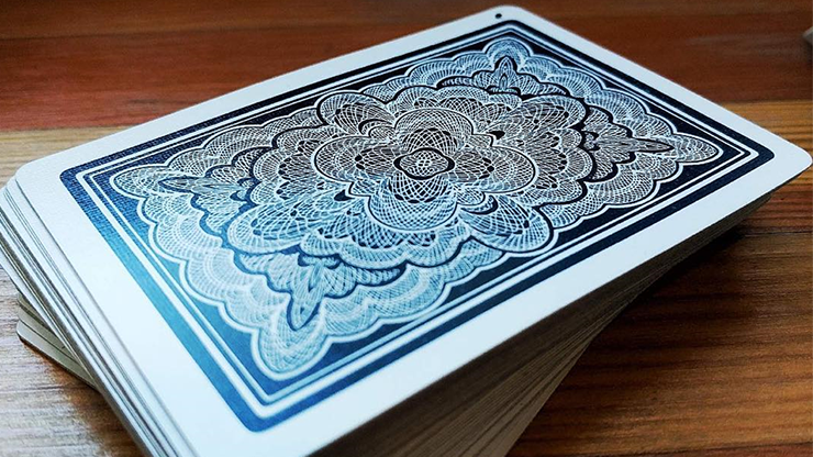 Stack of Blue Ribbon playing cards with a detailed blue and white design on a wooden surface