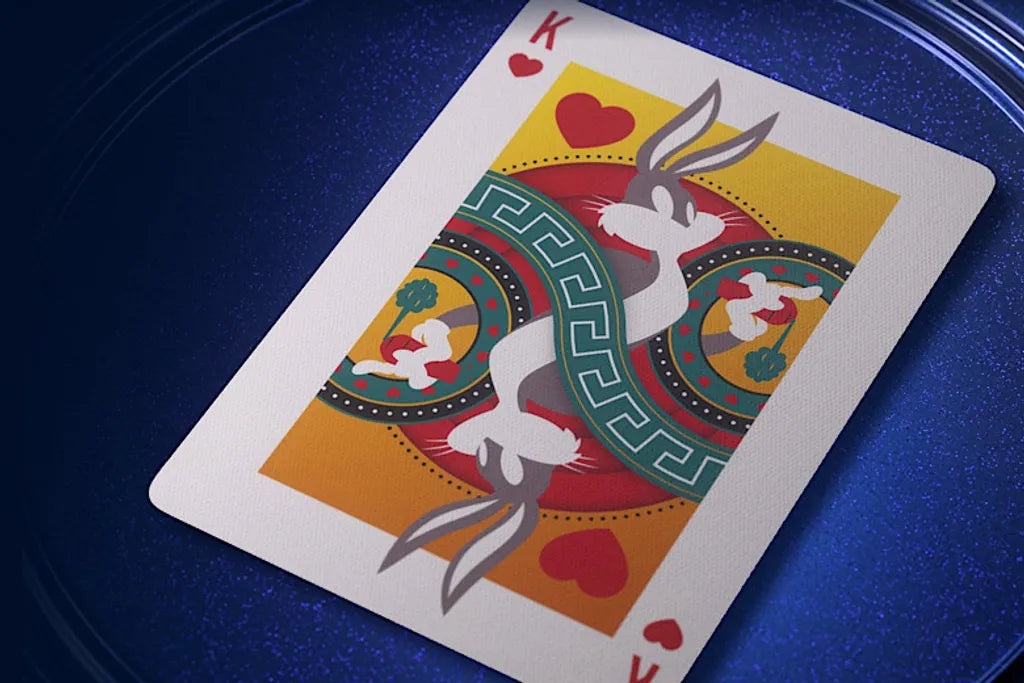 King of Hearts playing card with decorative border on a blue surface