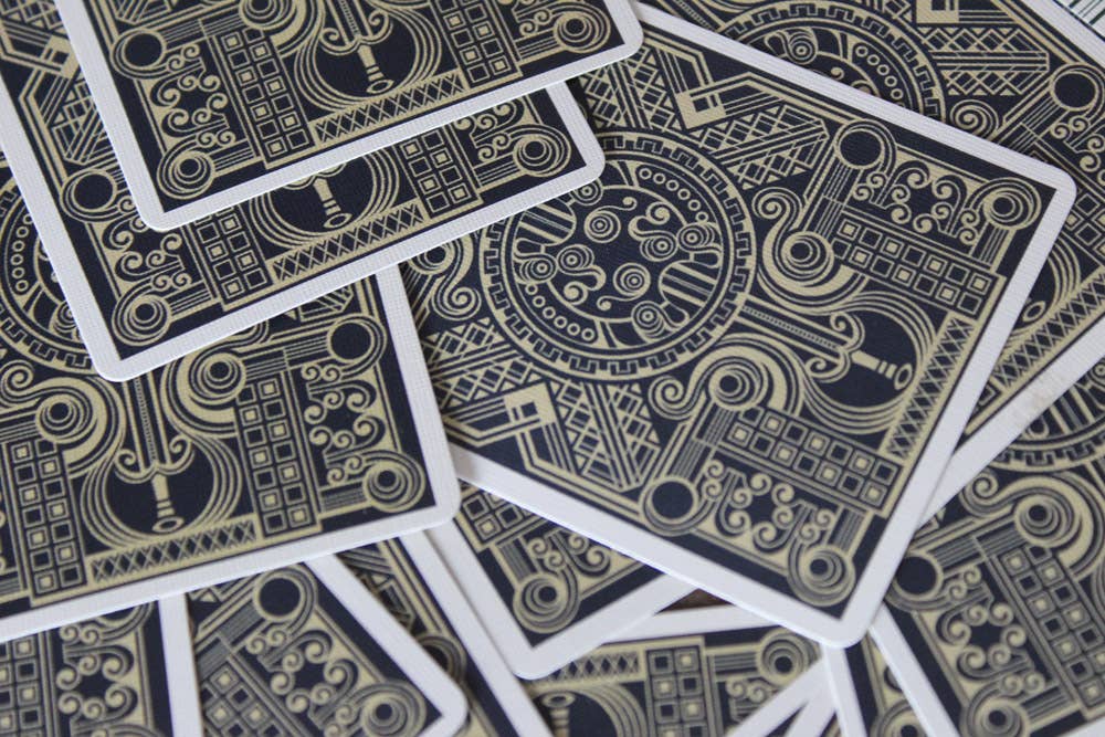 Black and gold playing cards with intricate designs.