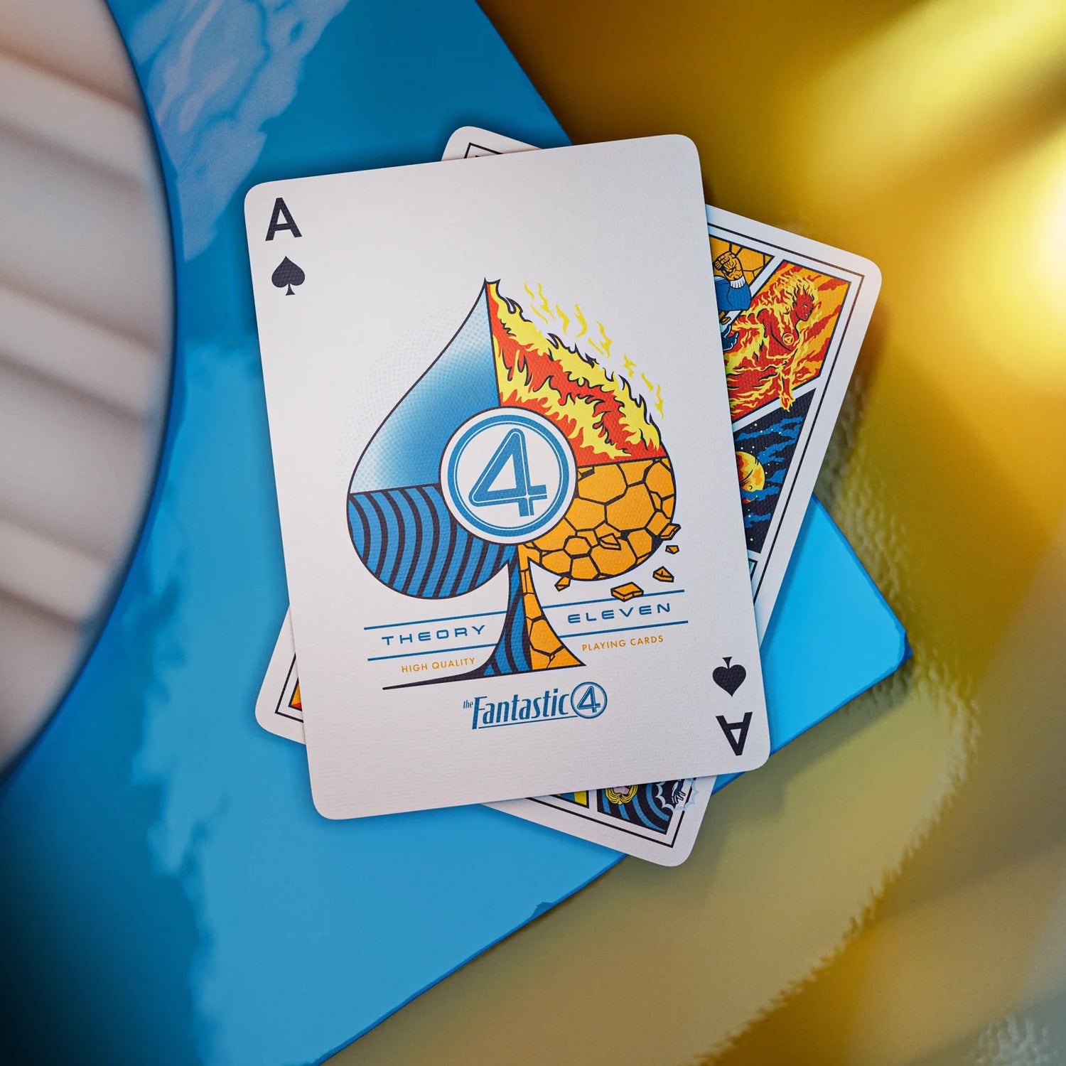 Playing cards with unique designs on a blue and yellow surface