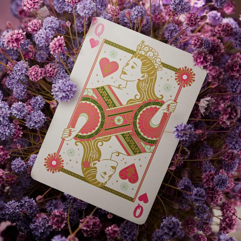 Playing card with a decorative design on a bed of flowers