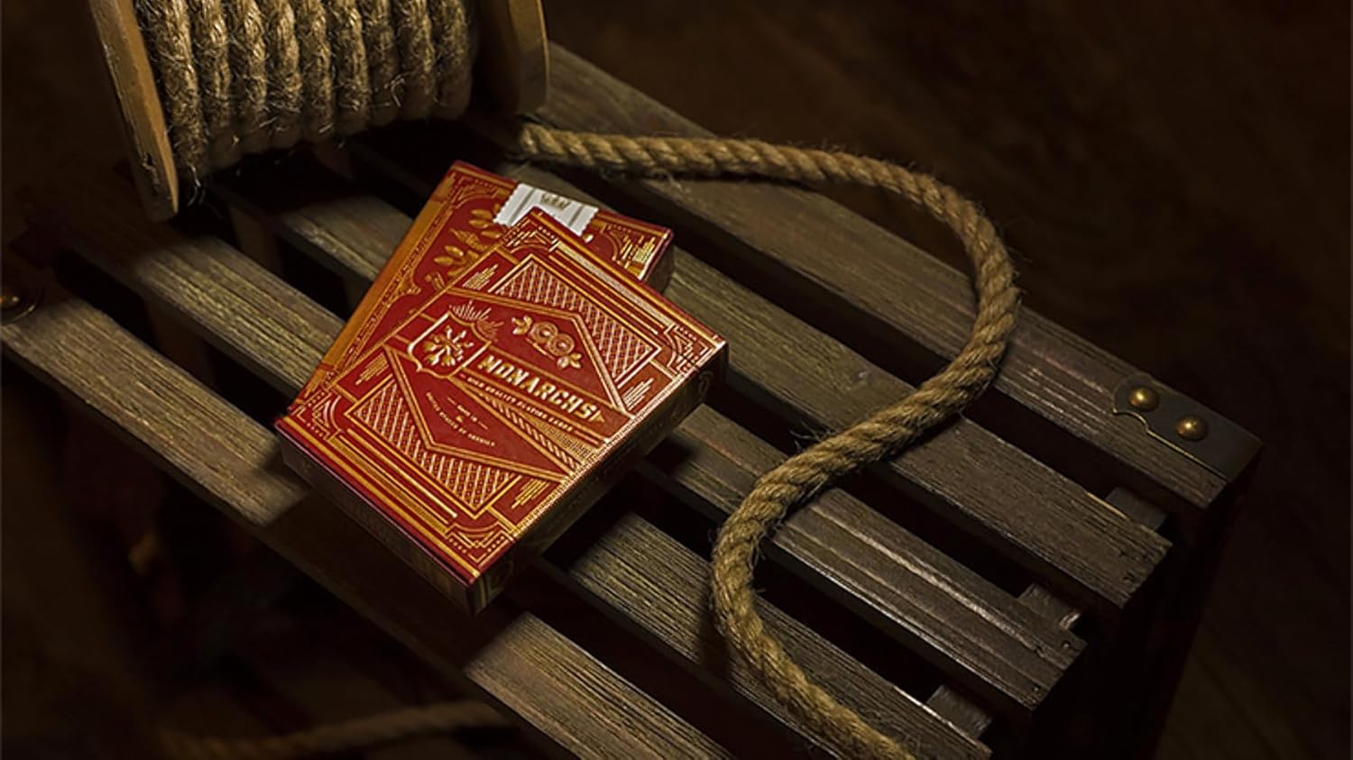 Red book with gold embossed cover on a wooden shelf with rope