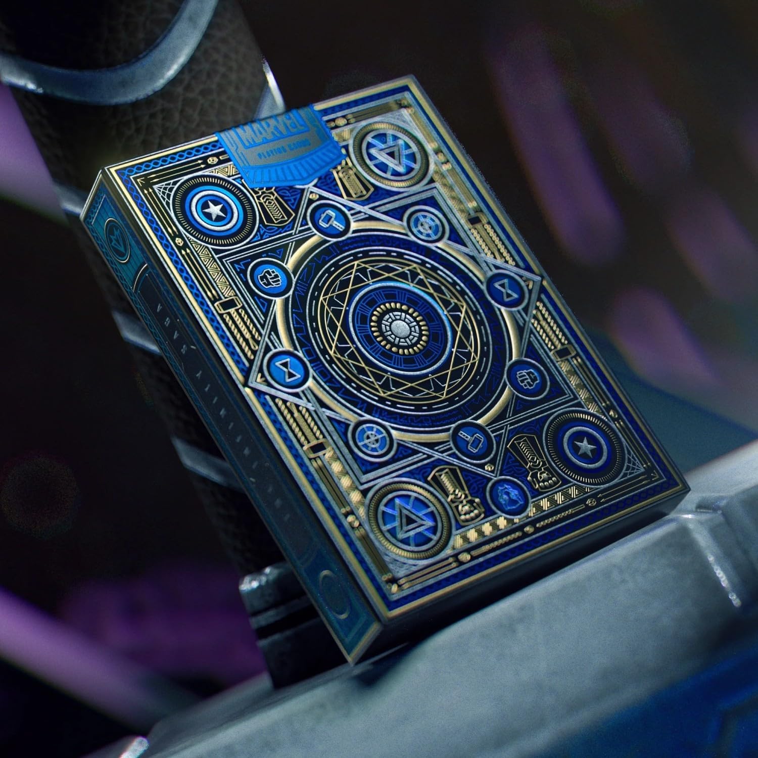 Blue and gold playing card with intricate designs on a dark background