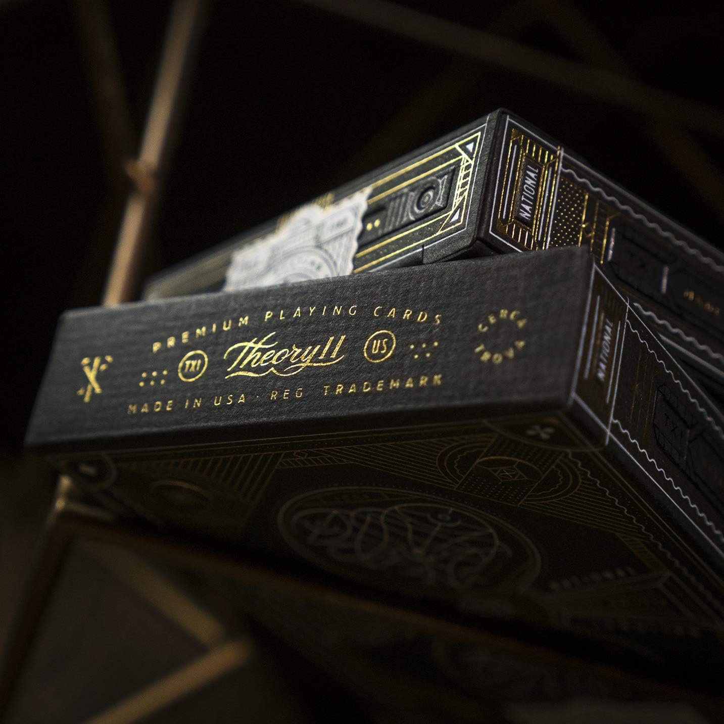 Theory11 premium playing cards with gold text on a dark background