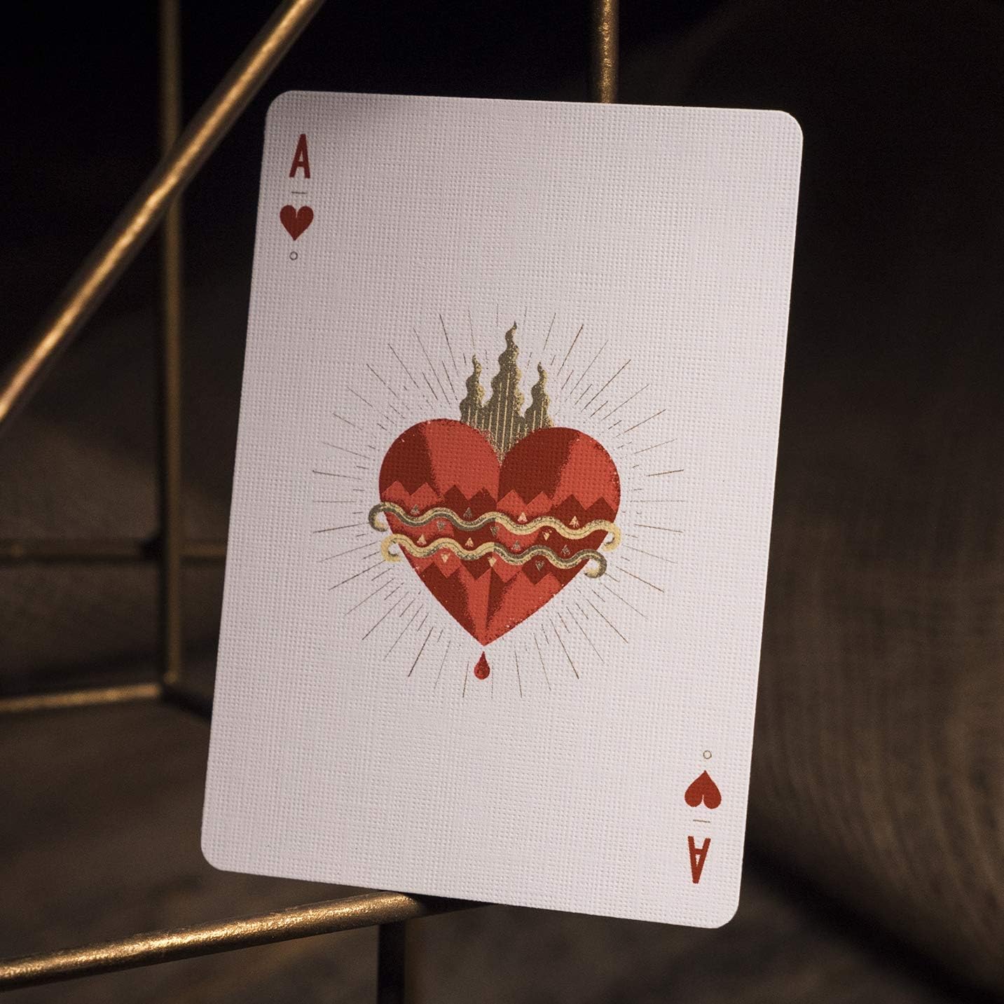 Playing card with a red heart design on a dark background