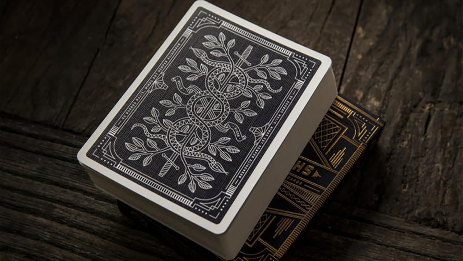 Playing cards with intricate design on a wooden surface
