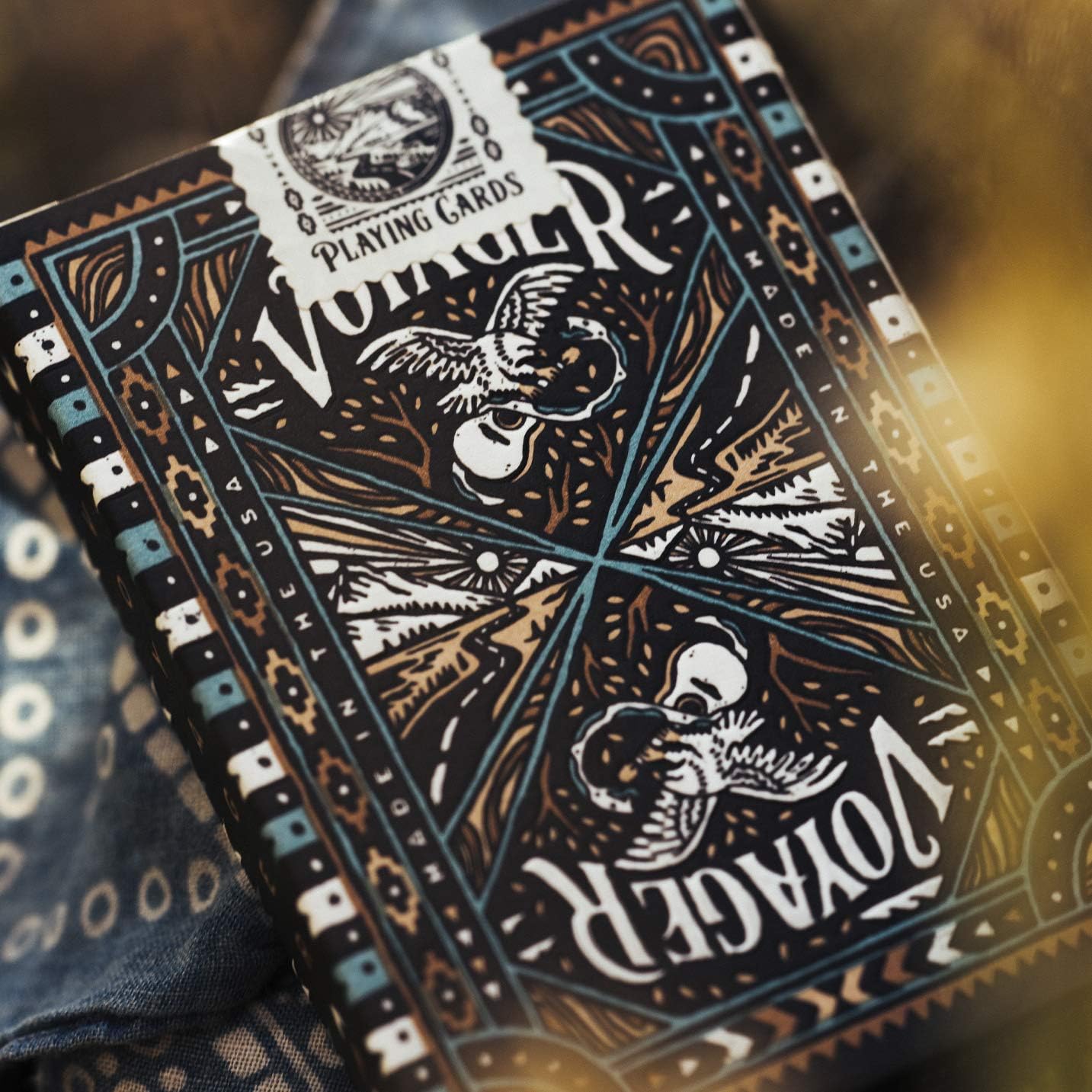 Close-up of Voyager playing cards with intricate design and branding.