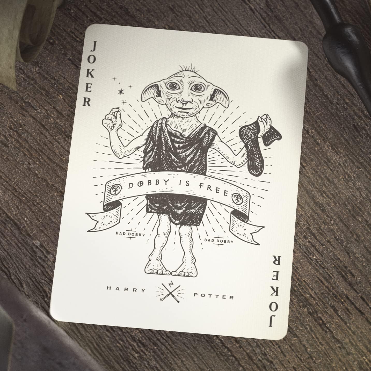 Playing card with a character design labeled 'Joker' on a wooden surface