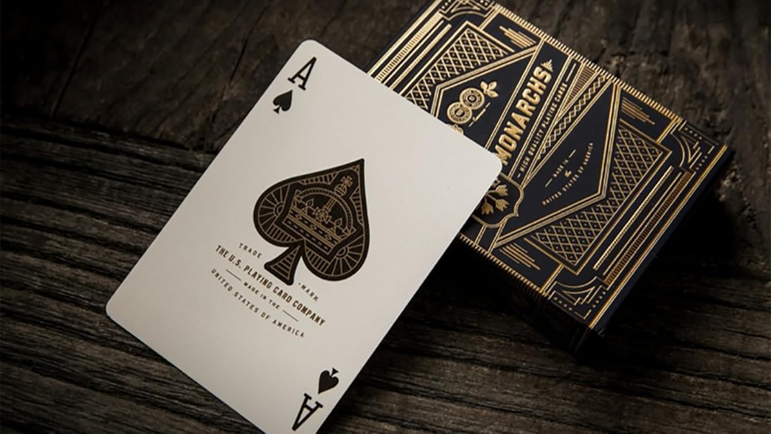 Playing card with ace of spades and a deck of cards on a wooden surface