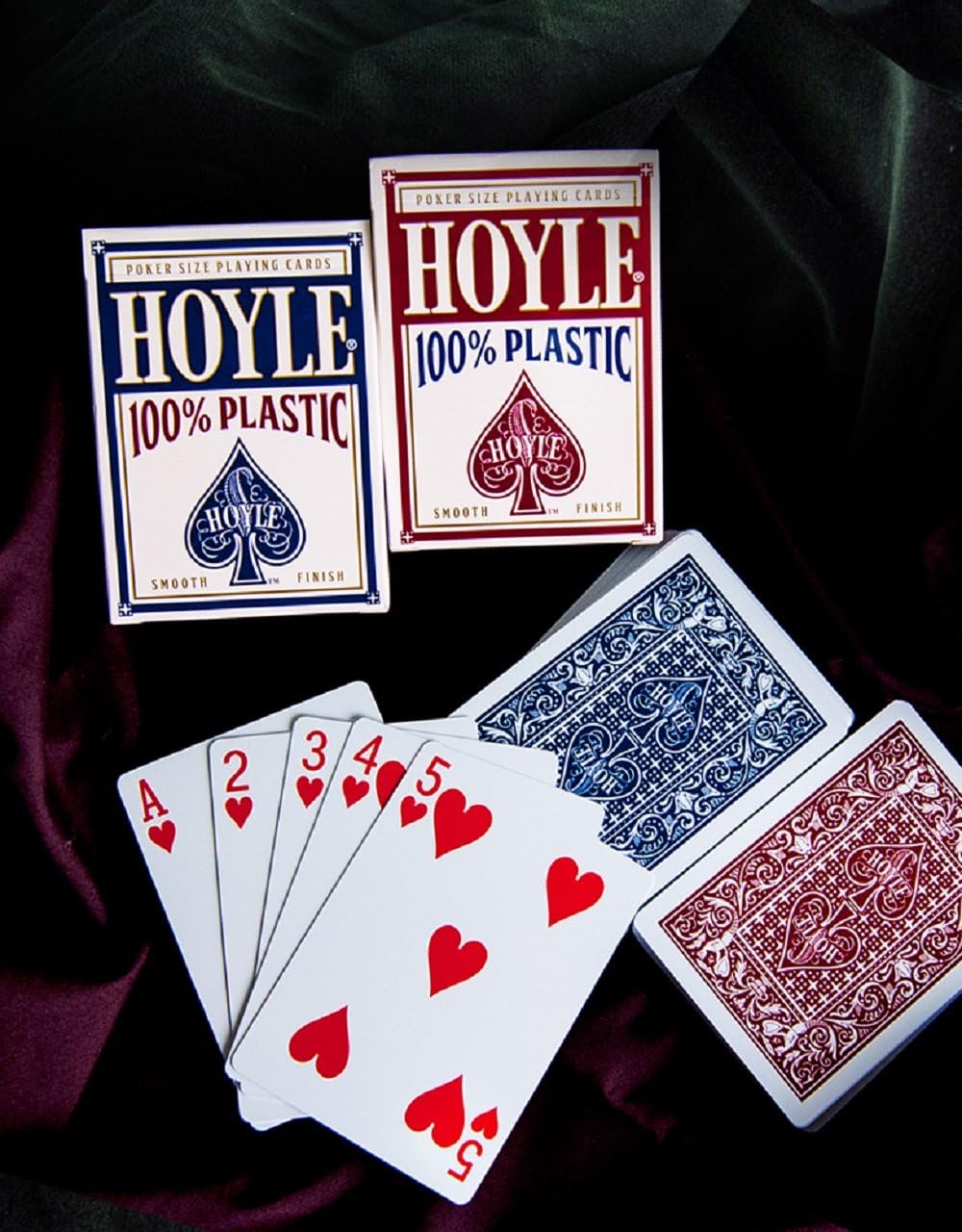 Hoyle 100% plastic playing cards in blue and red on a dark background