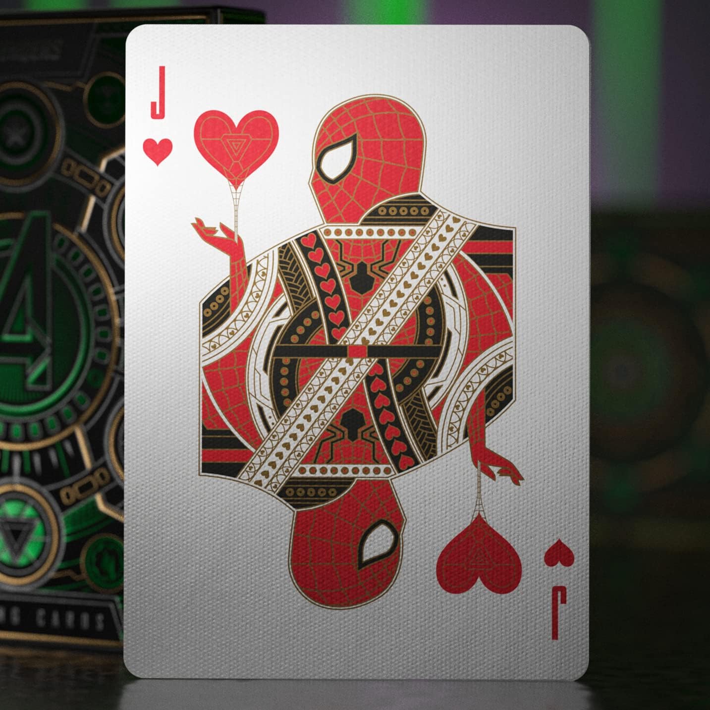 Playing card with a red and black superhero design on a blurred background