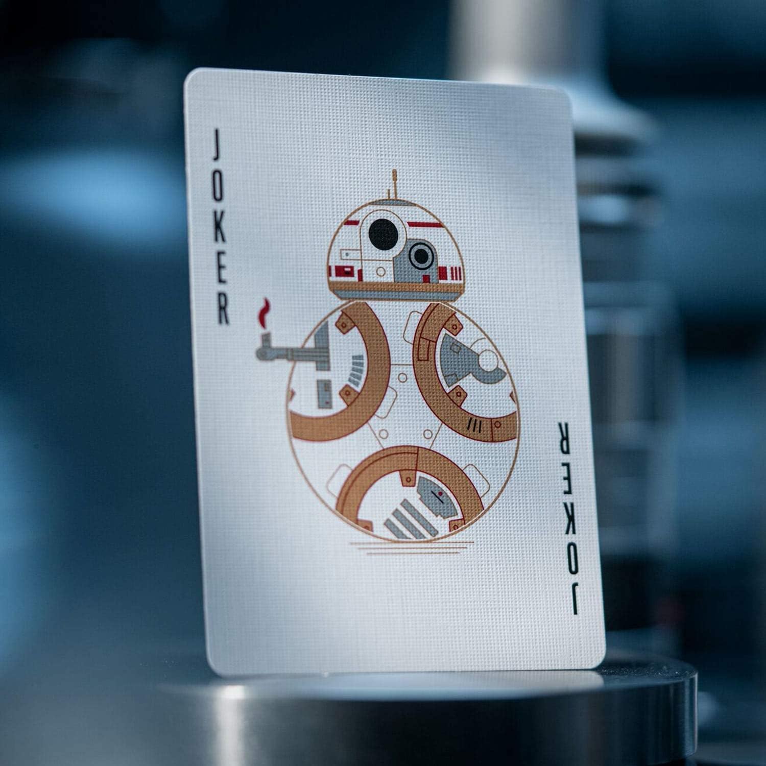 Playing card with a robot design labeled 'Joker' on a blurred background
