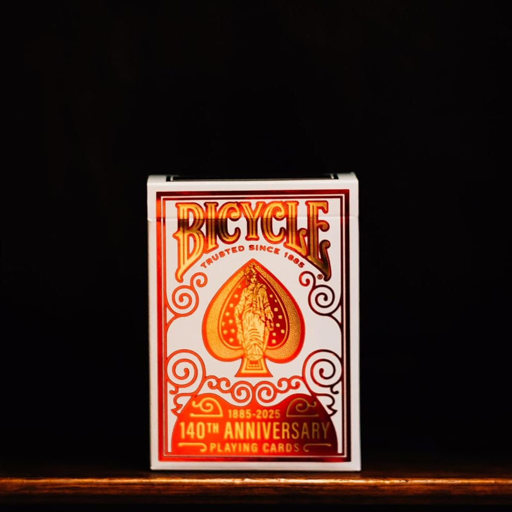 Bicycle playing card deck with 140th anniversary design on a dark background