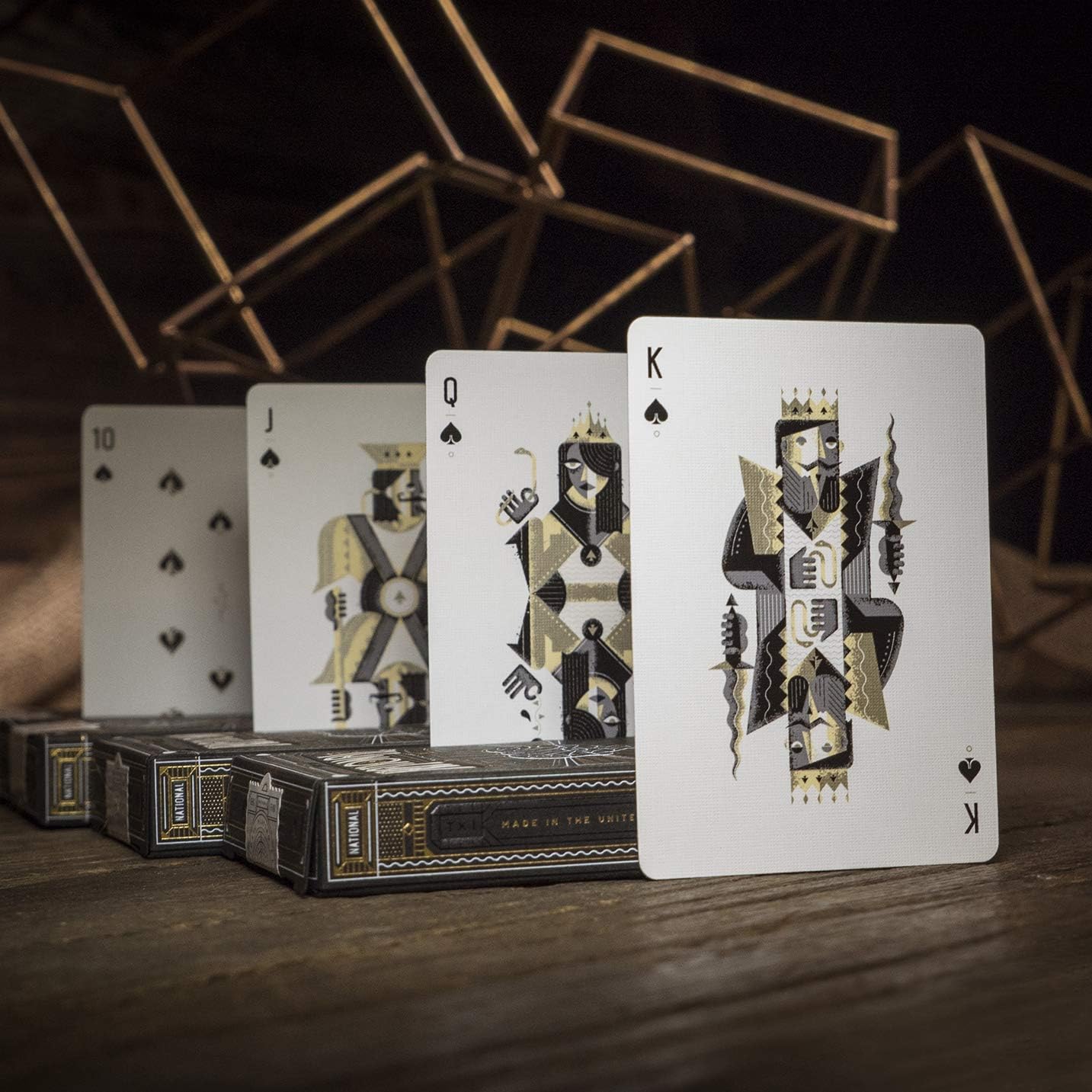 Playing cards with decorative suits on a wooden surface