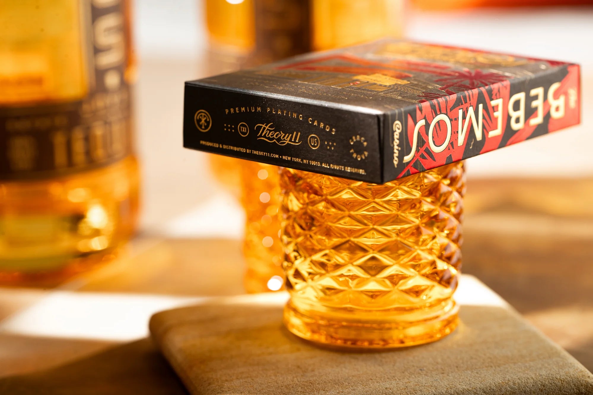 Pack of Bebemos Casino playing cards with a textured glass object on top